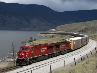 CP 8819 leads a westbound hotshot past the siding extension at Savona, as stormy skies brew over Lake Kamloops.
