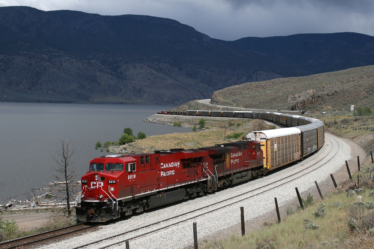 CP 8819 leads a westbound hotshot past the siding extension at Savona, as stormy skies brew over Lake Kamloops.