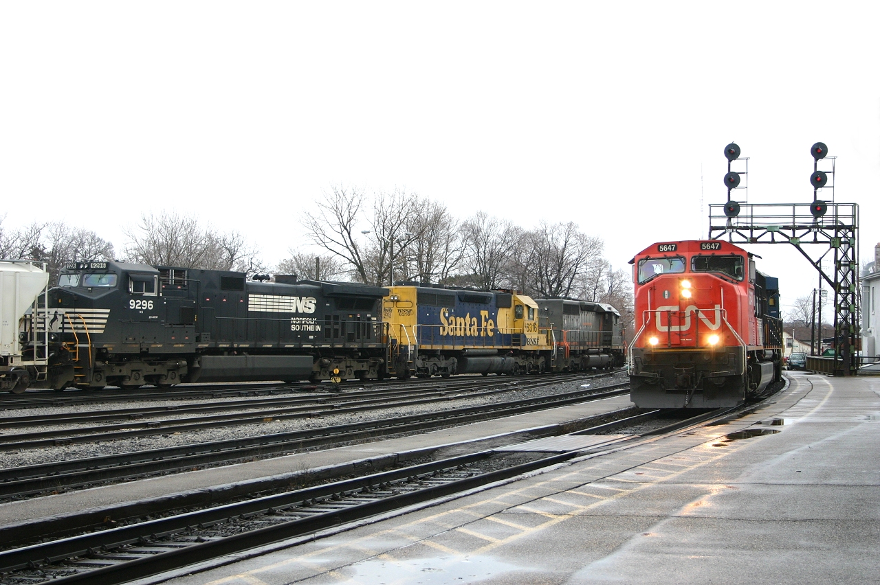 CN 393 led by CN 5647 and CSX 5219 rolls through Brantford as CN 398 works the yard with GCFX 6067, BNSF 6316 and NS 9296.