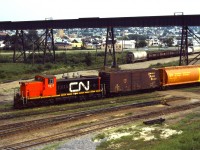 CN 1911 shuffles a CP grain box and a new Government of Canada grain hopper around at Thunder Bay North