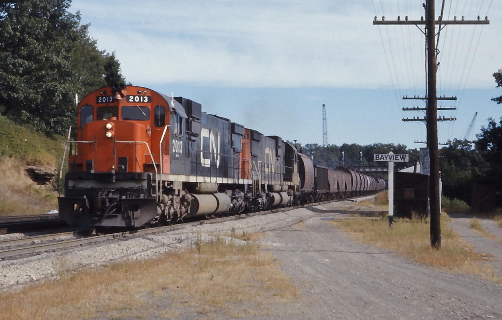 Train 441 powered by CN 2013 and 2015 ease through Bayview with a mixture of coal and ore cars bound for the Steel City
