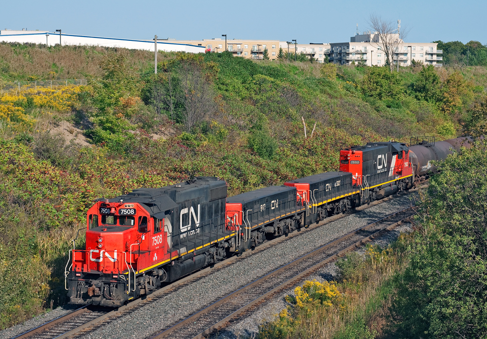 A pair of matching GP38-2's and slugs shove 3,000 ft of connecting traffic for the east crest to get humped at CN's MacMillan Yard.
