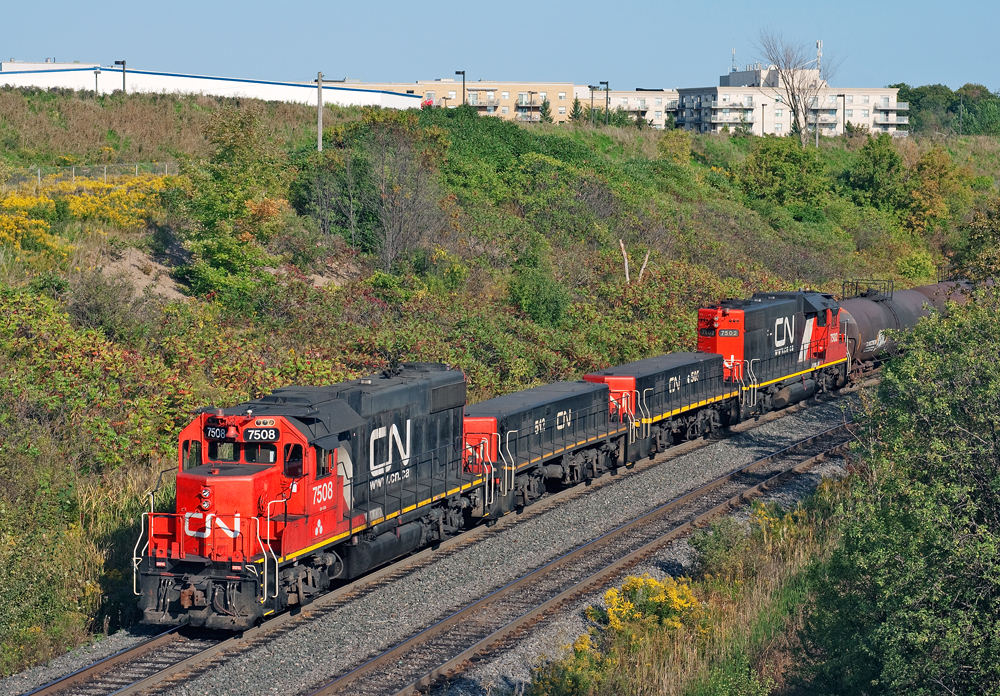 A pair of matching GP38-2's and slugs shove 3,000 ft of connecting traffic for the east crest to get humped at CN's MacMillan Yard.