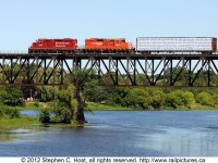After a recent IOP change under CP's new management, the Guelph Junction Turn, formerly known as the London Pickup trundles across the Galt bridge with CP9's 8250 and 8239 with lumber for Dumfries , Ontario. The train also had work at Ary and Wolverton en-route to finish at London Yard.