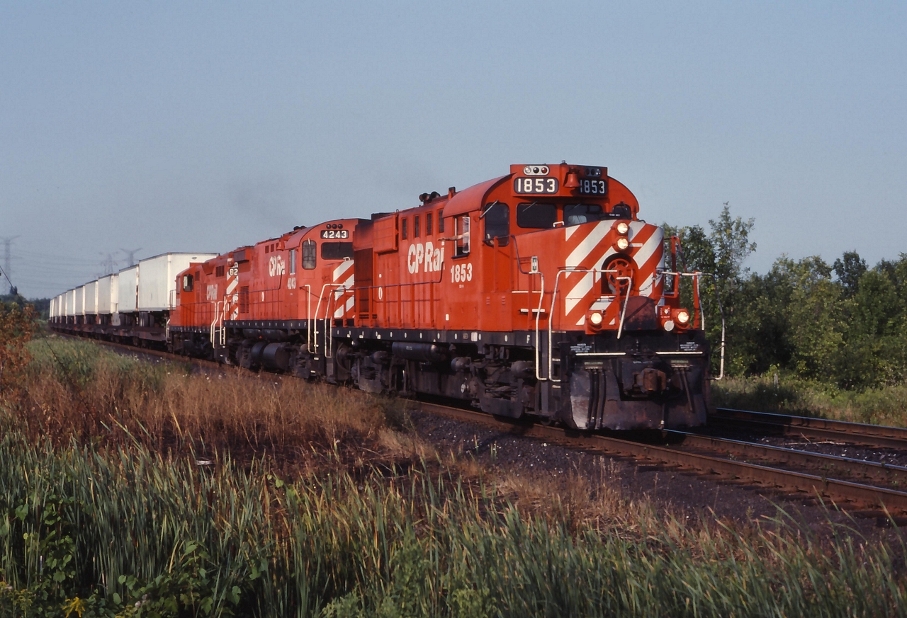 CP 1853, 4243 and a GP9 lead a westbound TOFC train through Cherrywood