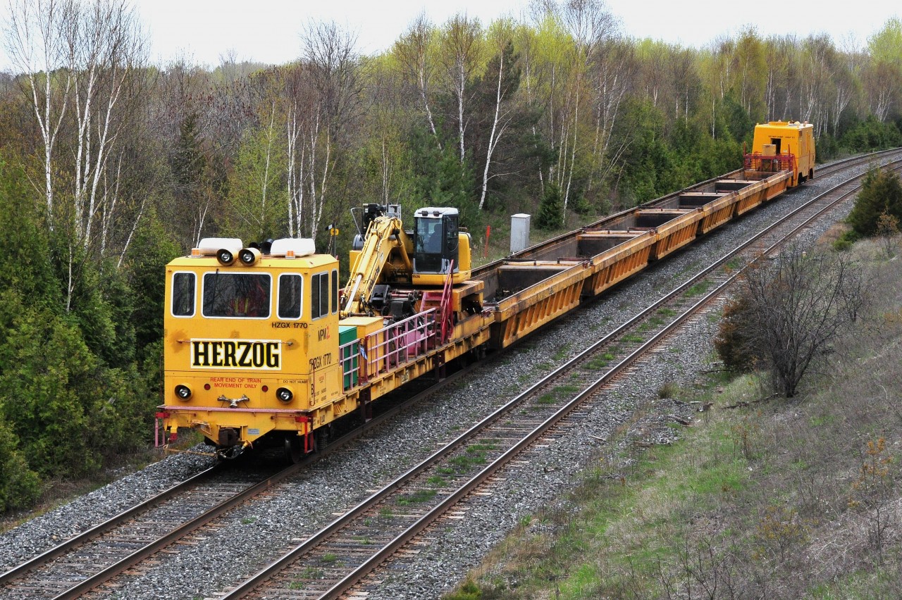 CN's tie replacement program is gearing up for another busy year as The Herzog proceeds east at its track speed 25 m.p.h near CN Belleville subdivision mile 277.8.  HZGX 1770's  May 10, 2010 destination is Belleville to pick up another load of ties. Image by S.Danko.