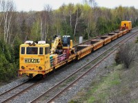 CN's tie replacement program is gearing up for another busy year as The Herzog proceeds east at its track speed 25 m.p.h near CN Belleville subdivision mile 277.8.  HZGX 1770's  May 10, 2010 destination is Belleville to pick up another load of ties. Image by S.Danko.