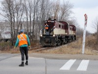 Before the new yard for Polymer Distribution Inc. (PDI) was built just west of Imperial Road in Guelph, the "North Industrial Spur" was only used as far MBI Smurfit (building to the left) and this crossing seen little use. However on occasion PDI would have overflow traffic that couldn't be handled at their main yard (located off Victoria Road) and would be spotted near the end of track for transload. On November 20, 2009 the brakeman on the OSR crew protected the rarely used Imperial Road crossing, as he radios to the enginer to move his pair of MLW RS-23's forward so they could grab the one hopper that had been spotted.