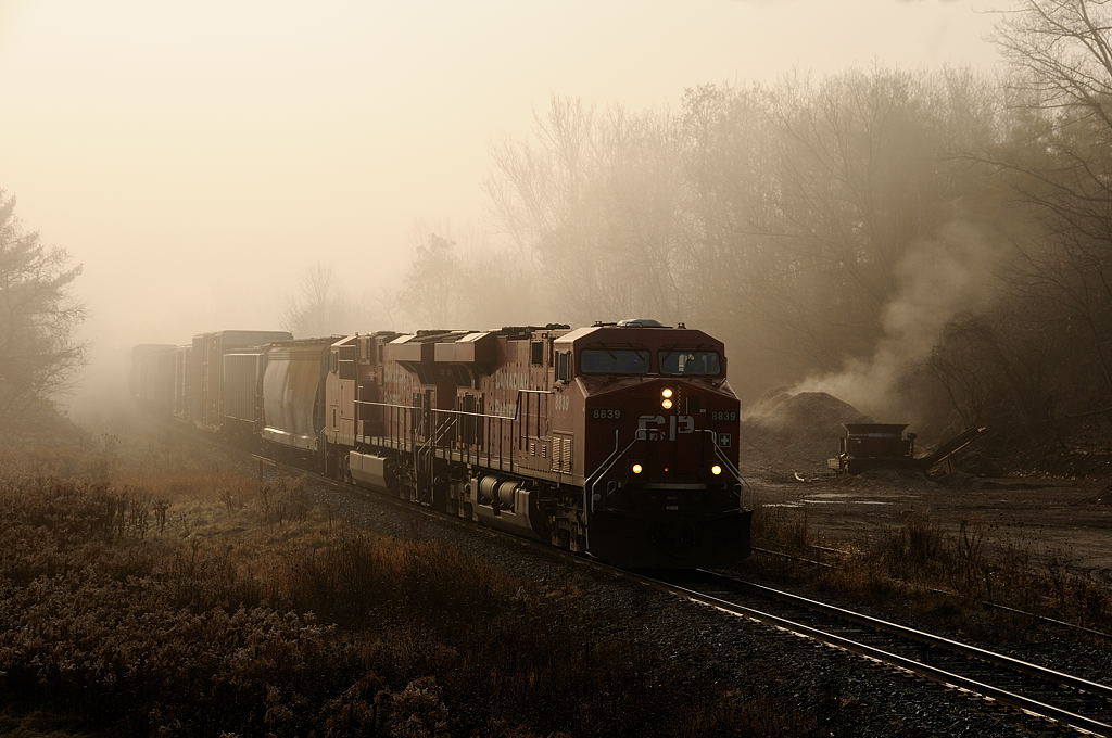 On a chilly fall morning, the fog begin's to lift in the rural town of Flamboro, as CP 8839 North emerges with Toronto bound freight 255.