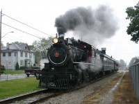During a torrential downpour, ETR #9 rolls through St Thomas with an excursion train.