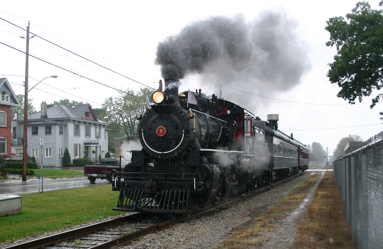 During a torrential downpour, ETR #9 rolls through St Thomas with an excursion train.