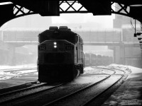 The weather outside is frightful, but on the train it's so delightful. GO F59PH 542 comes out of the falling snow under the train shed at Union Station, with Lakeshore East train 920 in tow for passengers waiting by Track 2. Let it snow, let it snow, let it snow.
