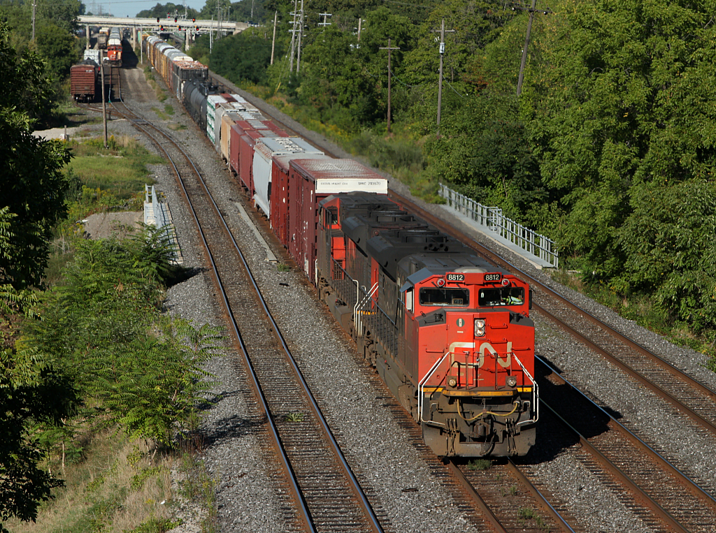 CN 383 passes through Aldershot with a pair of SD70M-2s, while the Aldershot yard job goes about it's work.