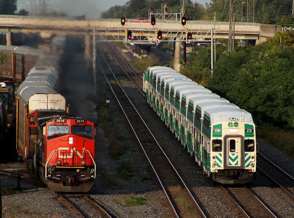 GO 495 highballs out of Aldershot, while CN 399 goes about setting off 57 multi-levels into Aldershot yard.