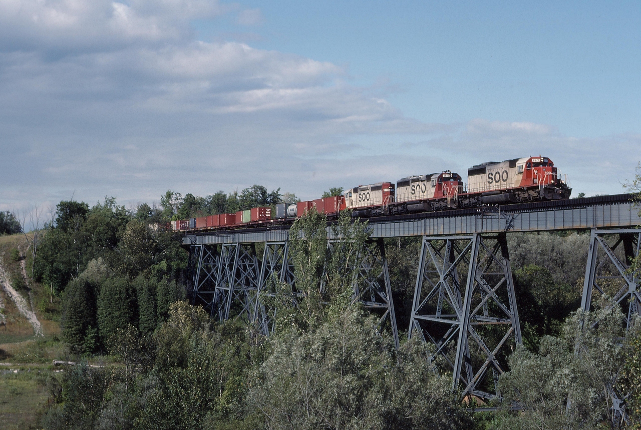 SOO 6620, SOO 6615, SOO 6610 power a Chicago bound container train over the bridge just east of Cherrywood.
