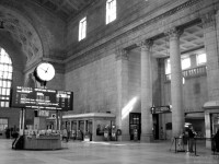 A quiet afternoon in Toronto's Union Station sees a few patrons buying their tickets and passing through the Great Hall, while the VIA departures board shows trains departing later in the day for Ottawa, Montreal, Windsor and London.