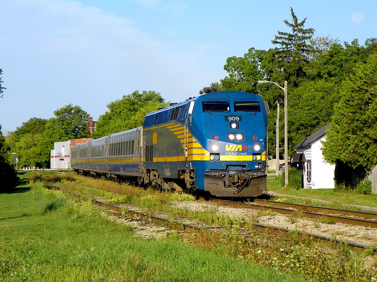Sunday morning sidewalk - VIA Train #84 arriving at Stratford Ontario - early morning sun.