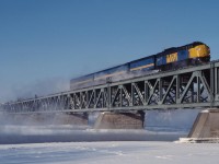 On a frigid December morning, VIA 22 soars over the Richelieu River bound for Quebec City with VIA 6505 on the point.