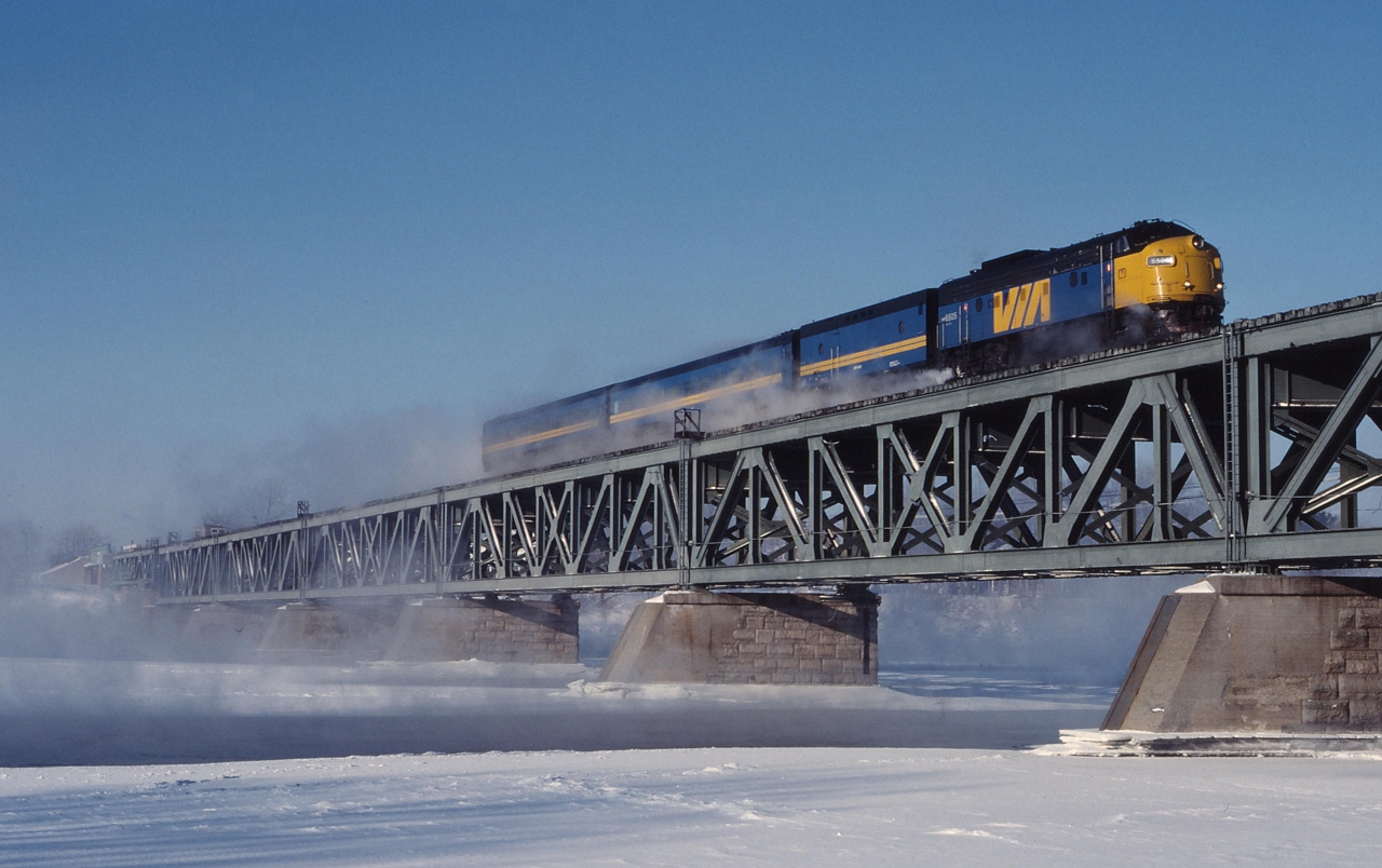 On a frigid December morning, VIA 22 soars over the Richelieu River bound for Quebec City with VIA 6505 on the point.