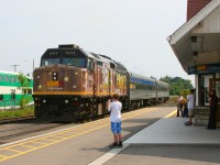 The station attendant, passengers and their families wave to the engineer on VIA 85 as they ease to a stop at Georgetown.