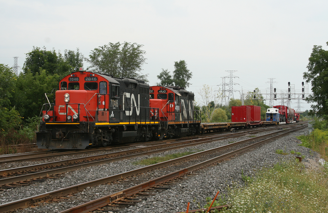 CN 7046 and 4100 slowly drag X556 towards the yard at Aldershot.  In tow is CEBX 800, the worlds largest Schnabel car carrying a piece of equipment manufactured at Hooper Welding in Oakville Ontario.  Over the next few weeks CN and BNSF would limp this massive load to its destination in Kansas