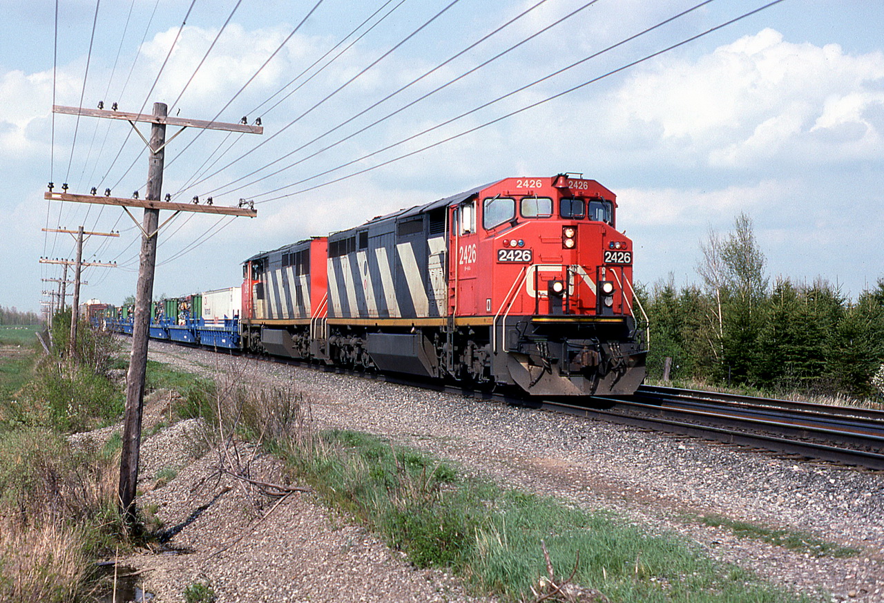 CN 207 approaches the curve and the crossing with 2 two year old GEs well liked by the crewmen.