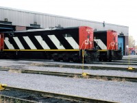 CN 2420 and 22 show their dull back ends as they poke their noses in the shop.
