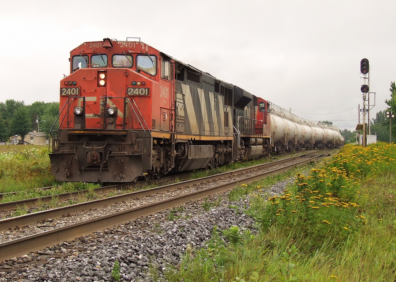 CN gas train 782 led by 2401 and 8002 gets in the hole with its MT 68 tanks to let the 401 go by.