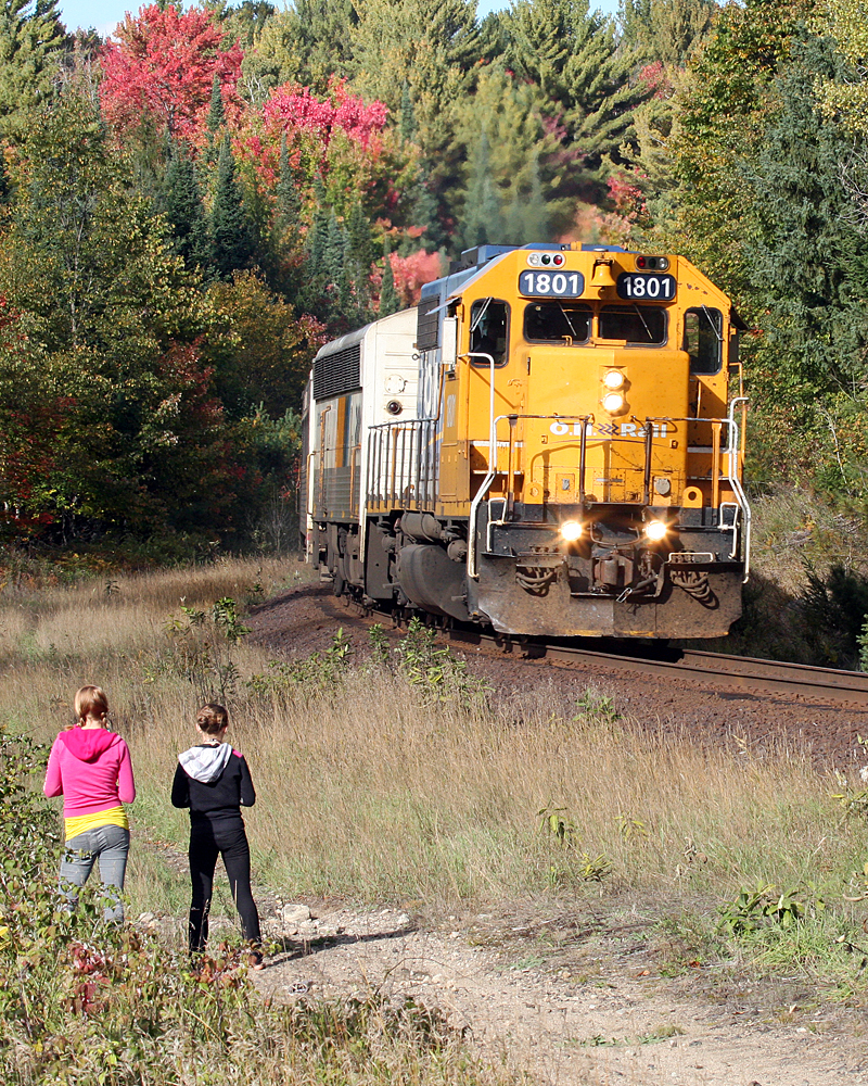 With only one more day of scheduled Northlander train service 1801 is greeted at Utterson by several folks inculding two guys from Germany and these two kids taking the back way home from school.