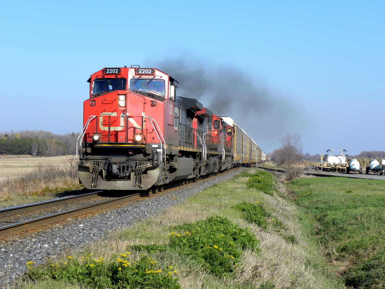CN 401,s engines 2202 2541 and 2551 are growling in the upgrade at 30-35mph after having stop to meet the long 120 2 miles east of here.