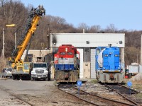 RLK 4095 and CEFX 2019 sit on the shop tracks as a crane offloads some machinery from a truck.