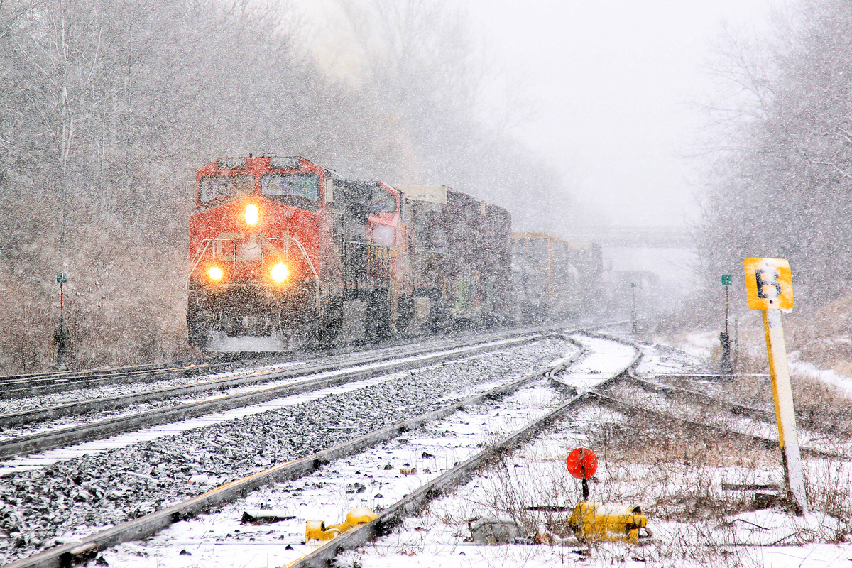 CN 2601 and 2128 approach the summit of the grade at Copetown amid a violent snowstorm.