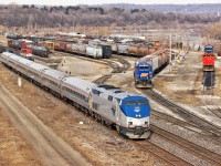 A rare Amtrak P40DC with VIA train 97 cuts through SOR Hamilton Yard while RLK 4057 sits waiting for a lift to Paris on 331, RLK 3873 classifies cars in the lower yard tracks and RMPX 9431 sits with four dead Geeps of various models and RA reporting marks.