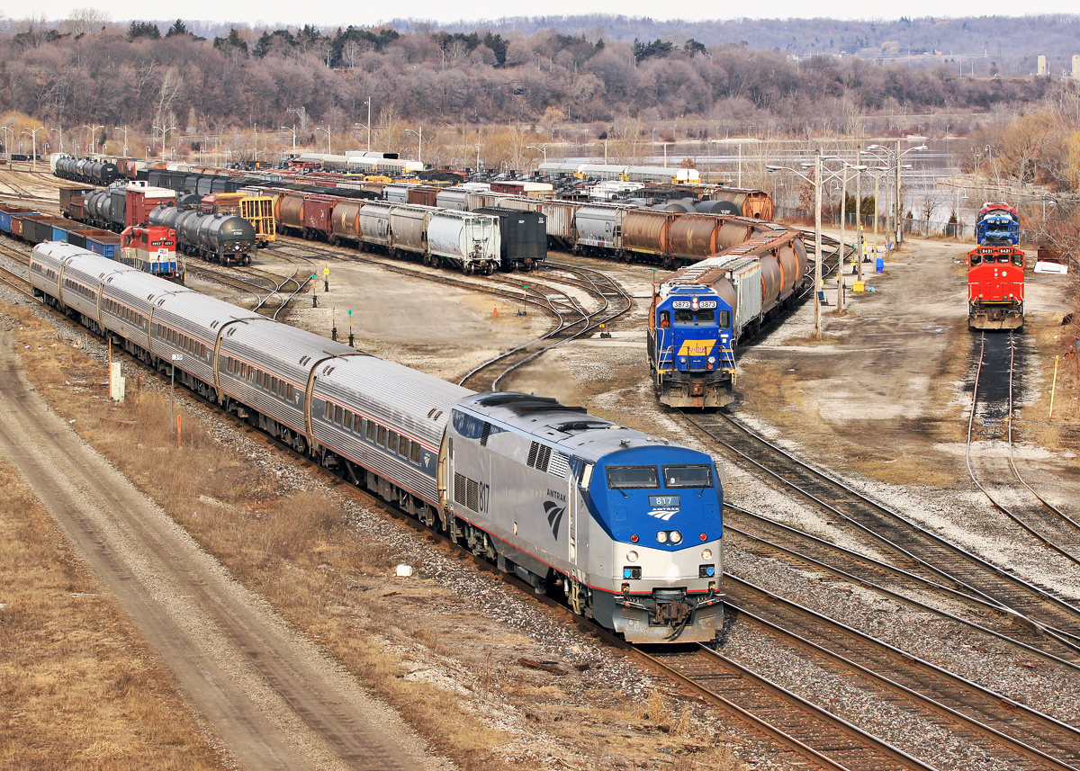 A rare Amtrak P40DC with VIA train 97 cuts through SOR Hamilton Yard while RLK 4057 sits waiting for a lift to Paris on 331, RLK 3873 classifies cars in the lower yard tracks and RMPX 9431 sits with four dead Geeps of various models and RA reporting marks.