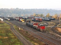 A Halloween treat: A pair of RailAmerica motors switch Hamilton Yard while a rare USSX 85 sits awaiting movement to its owners on the Waterfront and AMTK 145 swiftly moves through the fog with VIA 97s train.