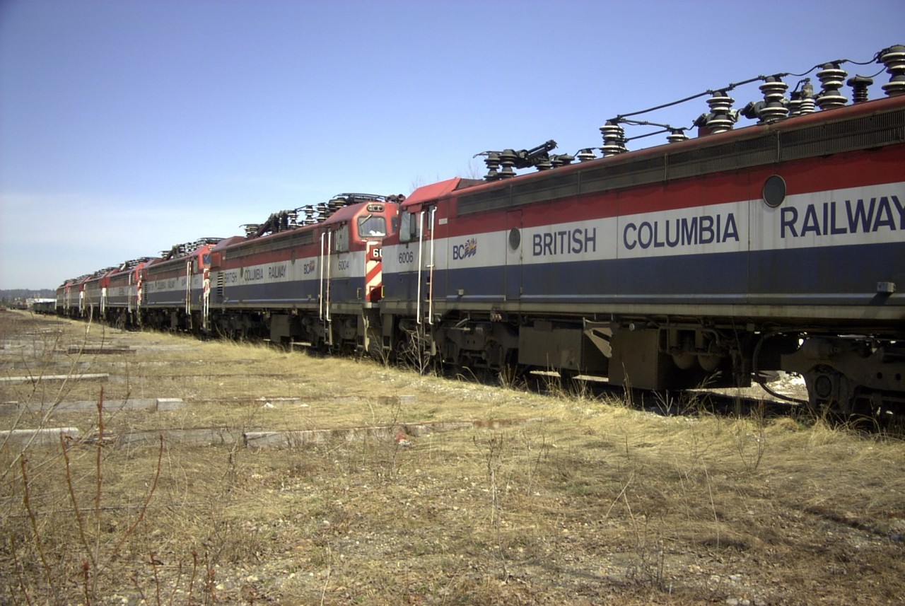A congo line of retired BC Rail electric locomotives sits in Prince George yard on a cool but sunny May afternoon.