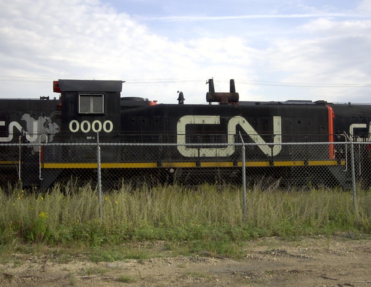 [Editors note - accepted for equipment rarity] CN 0000 sitting idle just outside the fenced compound of CN's Transcona Work Equipment Repair Facility.