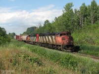 Heading downgrade on a sunny day, CN 393 with cowl-units 2410 and 5434 head past Mile 30 of CN's Halton Subdivision, on their way to Burlington and beyond.