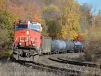 CN train 435 is rounding the curve at the site of the old Dundas station (long since removed). Half way up the Hamilton Escarpment grade, it will be another 5 miles before the grade ends at Copetown.