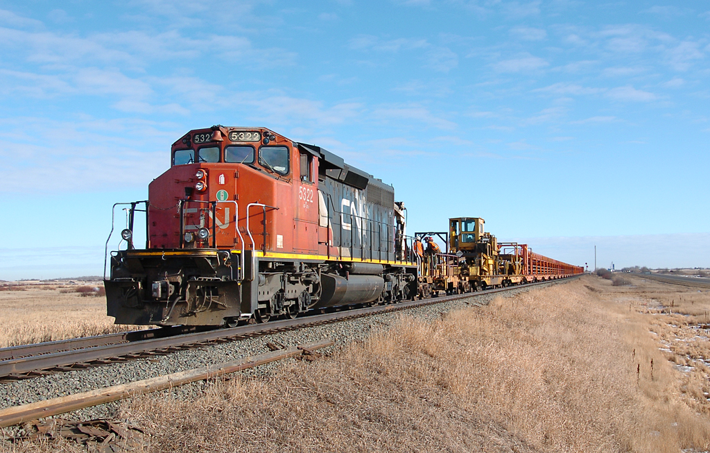 This CWR train came out West  of Ryley to pick up a few sections of replaced CWR lying on the roadbed, and then backed up to allow an Eastbound freight to go by.