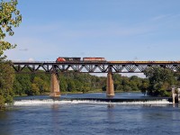 CN 331 crosses the Grand River in Paris, ON with a string of new well cars from National Steel Car in Hamilton. 