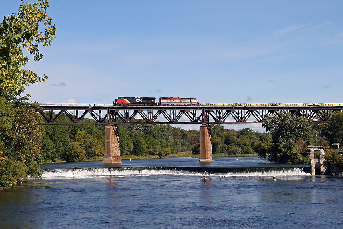 CN 331 crosses the Grand River in Paris, ON with a string of new well cars from National Steel Car in Hamilton.