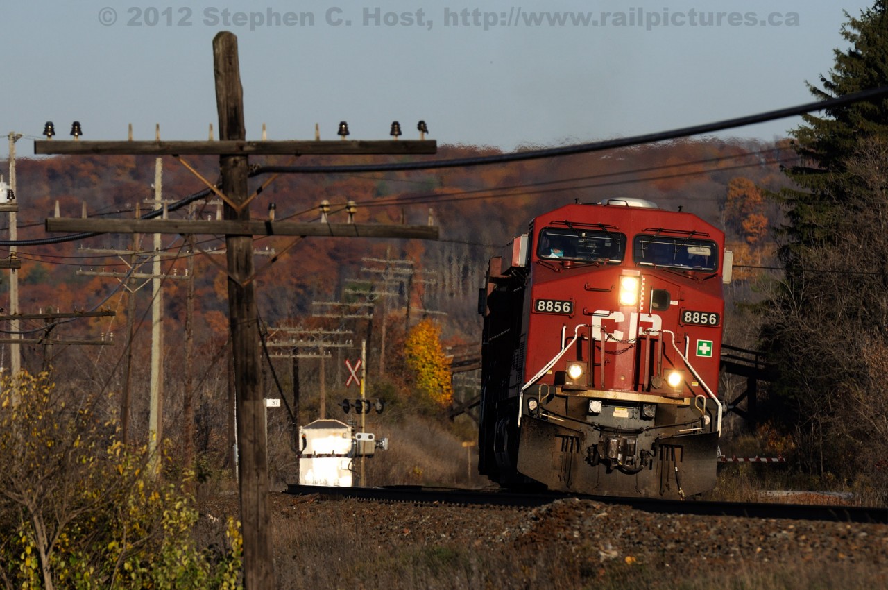 With fall colours showing their deepest hues of brown and orange, CP Train 141 with 10,000 feet of baretable and automotive traffic grinds up Campbellville hill on this late October evening.