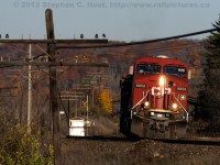 With fall colours showing their deepest hues of brown and orange, CP Train 141 with 10,000 feet of baretable and automotive traffic grinds up Campbellville hill on this late October evening.