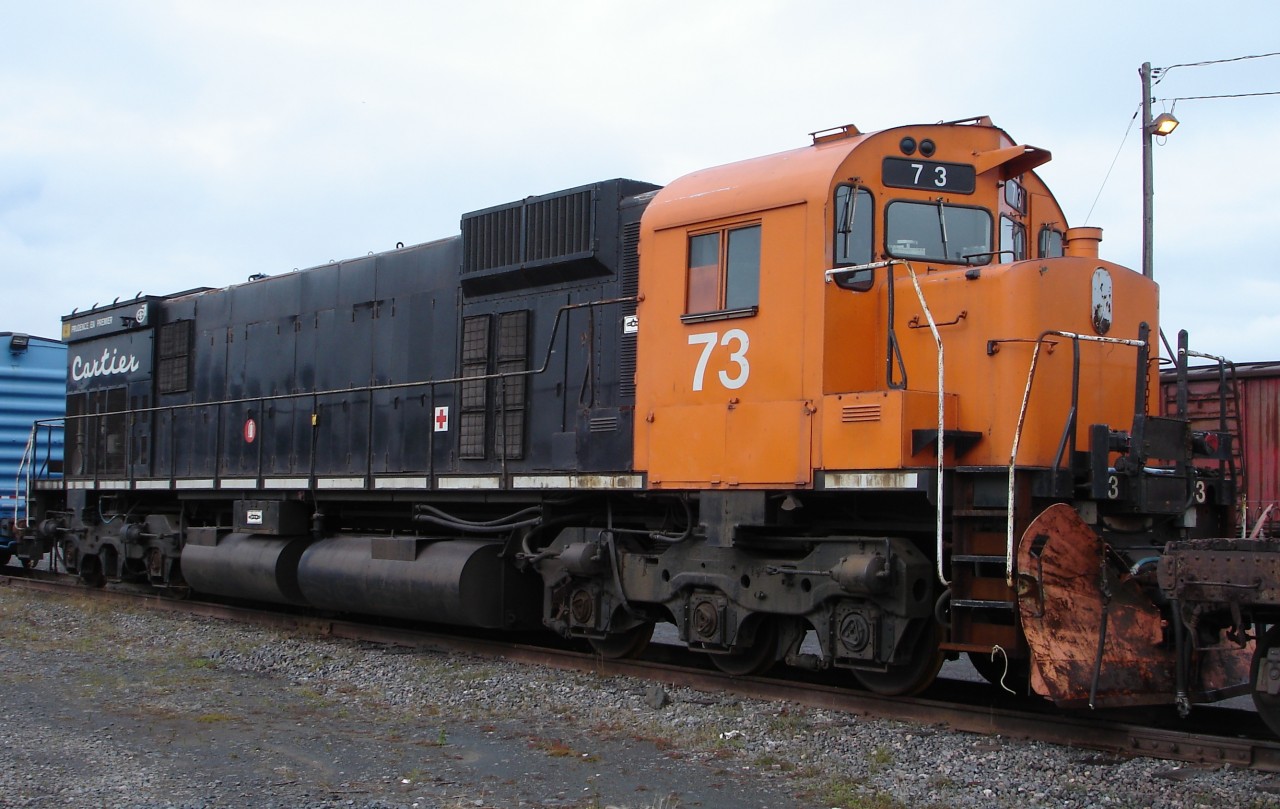 Cartier #73 sits quietly at the Port Cartier diesel shop where its life as a heavy haul unit has come to an end and it is gradually being picked over for useable parts to keep other roadworthy power up and running.  The missing bell and dual beam headlight are the obvious signs that 73 has become a doner.
