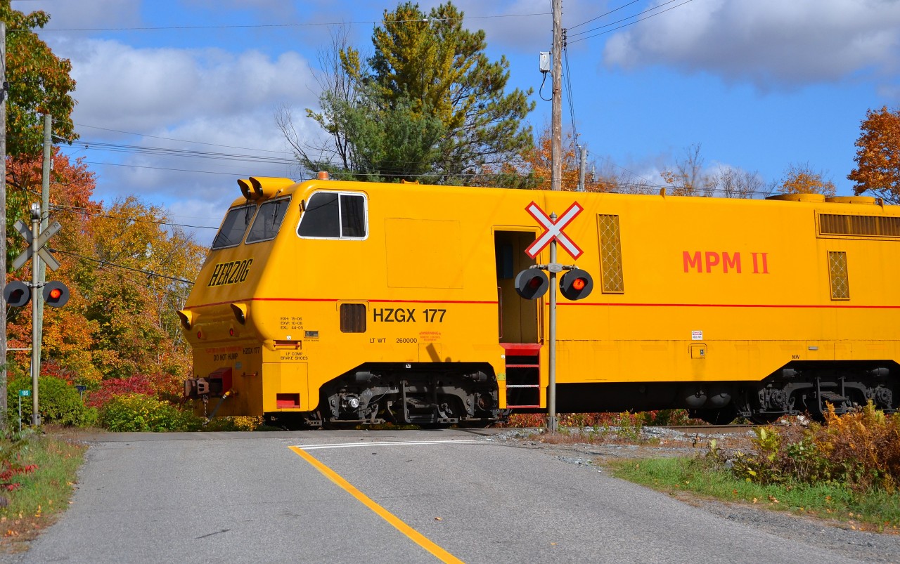 The tail end of the Herzog work train passes the Rosseau Road crossing at mp 138.70 CN Bala Sub as it proceeds southbound towards Dock Siding.