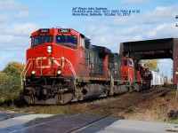 CN 2661 5659 & 2663 leading #369 has just lifted yard switchers 7082 & 4135 along with some loads at Belleville.  The train heads west at the Moira River, Belleville October 11, 2012  