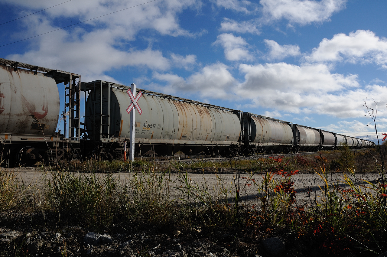 Empty hoppers labelled CNLX, NAHX and NCHX are only a few examples of the intials stencilled on the cars rolling behind ONR GP40-2 2202 and GP38-2 1809 along the rickety Kapuskasing Sub. Only a couple miles from hitting the Agrium Spur, named after the customer it services, the crew will head almost directly south to deliver the empties and lift the outgoing loads of potash and return to Hearst by days end.
