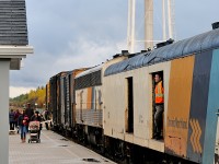 Standing in the entrance of the baggage car 412, an employee stares intently down First Street in Moosonee as passengers load their belongings into boxcars before boarding the train for the trip south to Cochrane and the flag stops inbetween.