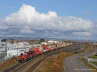 8927-8836 lead a short fast freight (113-17) into Thunder Bay, rolling past the empty yard in Current River. Thunder Bay seems to have the largest pocket of sunshine as huge clouds swarm the city in all directions.